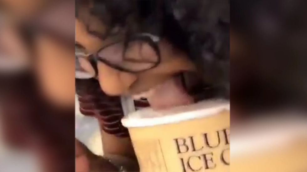 Woman licks open ice-cream tub and puts it back on shelf in Lufkin, Texas