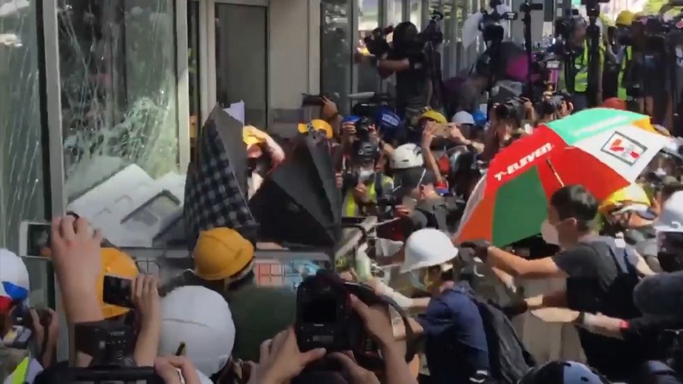 Protesters attempt to smash into Hong Kong legislature