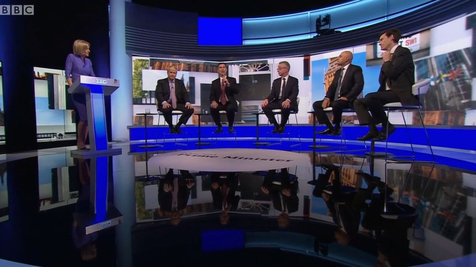 Rory Stewart removes his tie during the Tory leadership debate