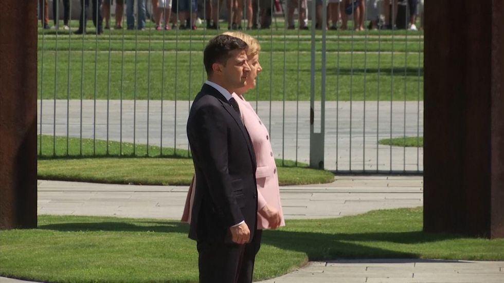 Angela Merkel visibly shaking during honour guards ceremony