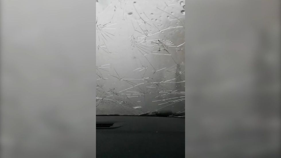 Hailstones the size of ping pong balls smash driver's windscreen mid-journey