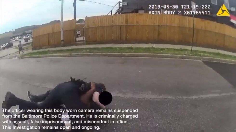Bodycam footage shows police tackling bystander in Baltimore