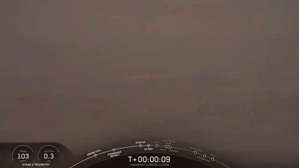 Space X rocket emerges through clouds in Falcon 9 launch