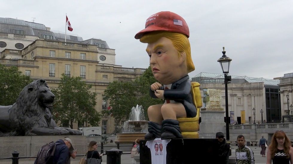 Giant model of Trump sitting on golden toilet while tweeting appears in central London ahead of protests