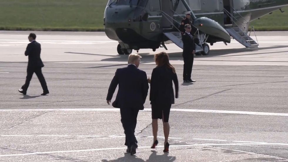 Melania appears to refuse Donald Trump's attempt to hold hands as they arrive in UK