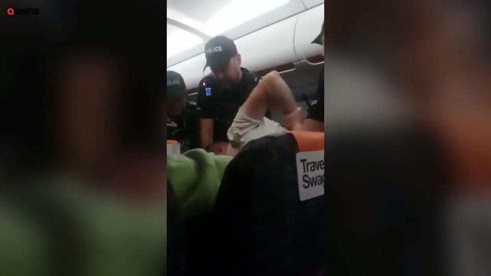 EasyJet passenger dragged off plane by police after locking himself in toilets