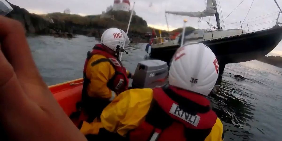 Two people rescued after 25-foot yacht gets stranded on rock off ...