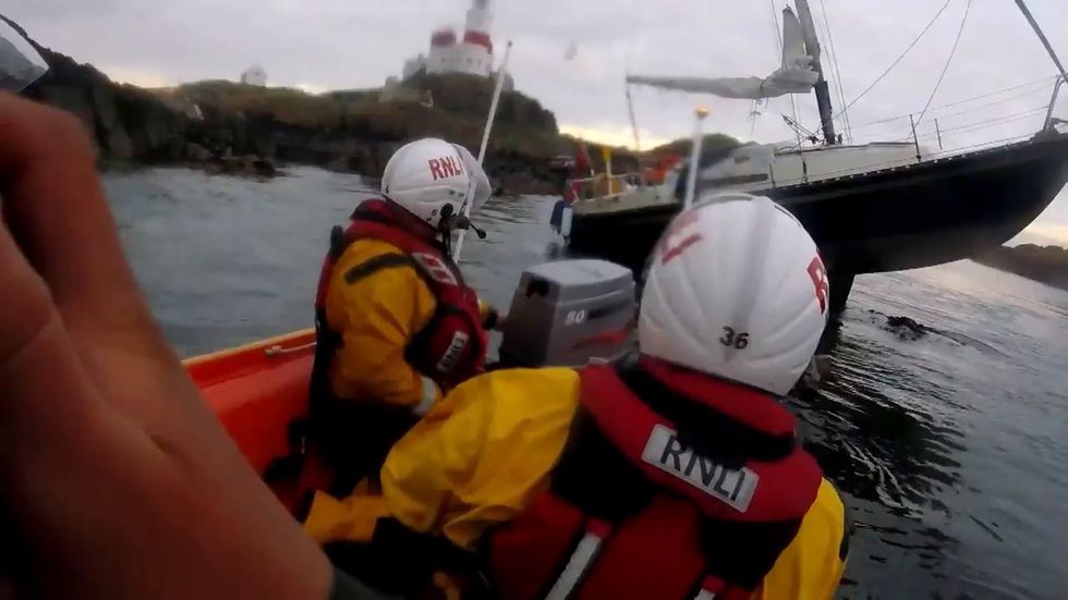 Two people rescued after 25-foot yacht gets stranded on rock off Anglesey coast