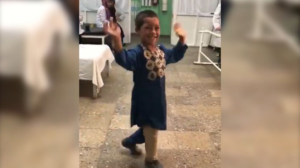Boy in Afghanistan dances after he receives his prosthetic leg