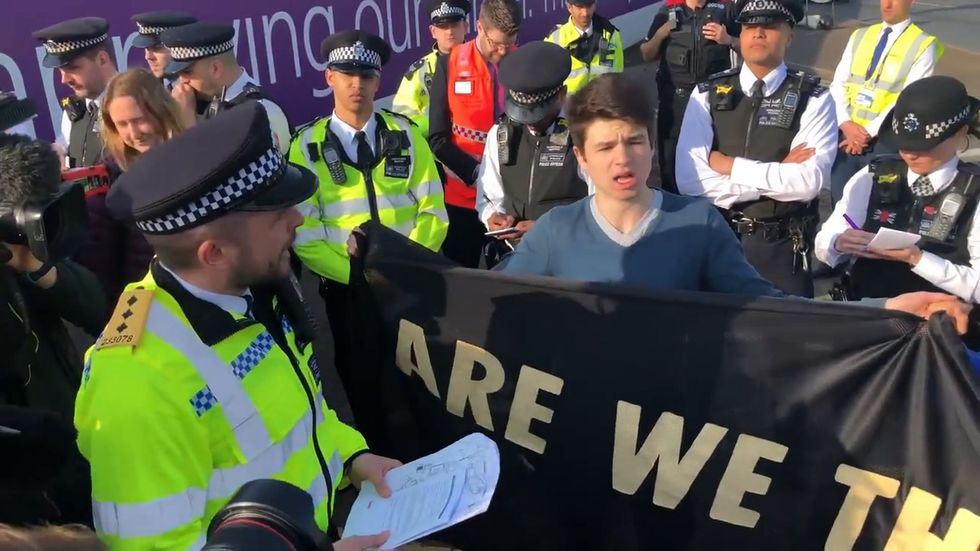 Extinction Rebellion: Youth protesters at Heathrow read Riot Act by surrounding police