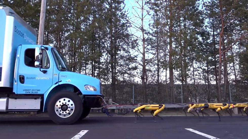 Watch pack of Boston Dynamics robot dogs pull lorry