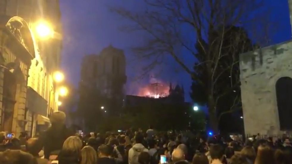 Moving video shows crowd singing Ave Maria amid Notre Dame fire as sun goes down in Paris