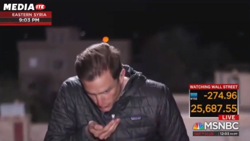 Revolting moment MSNBC correspondent caught on camera using his own spit to slick back his hair