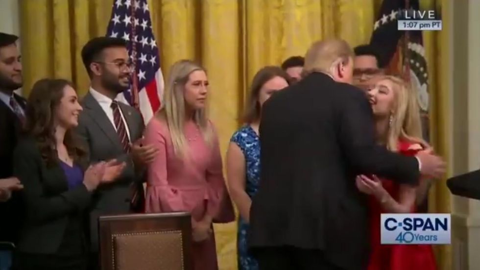 Awkward moment Trump appears to kiss a student's face after signing  executive order