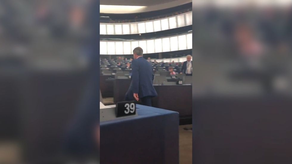 Nigel Farage leaving Brexit debate after giving his speech