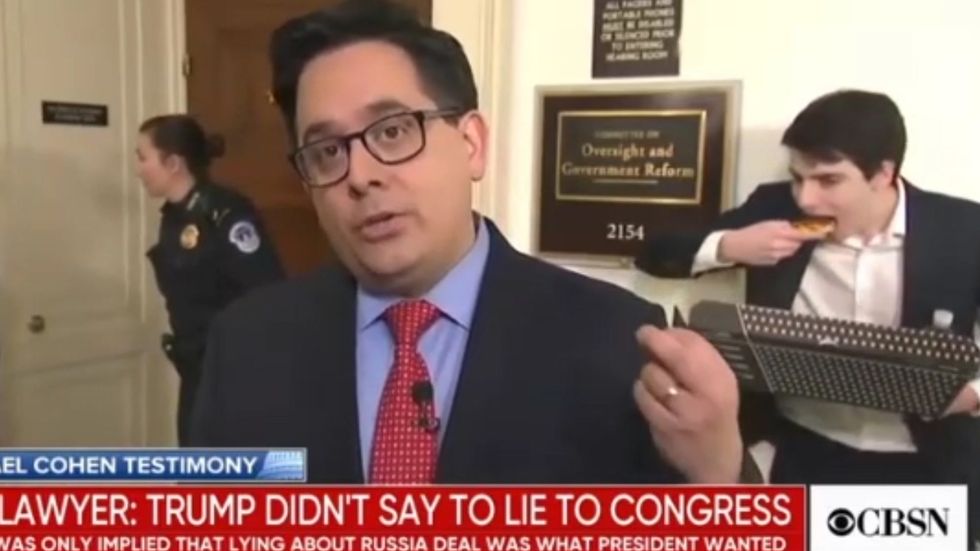 Reporter photobombed on air by congressional staffer eating pizza