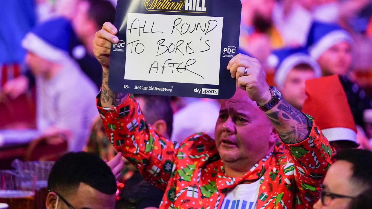 Darts fans troll prime minister with cheese and wine signs and chant ‘stand up if you hate Boris’