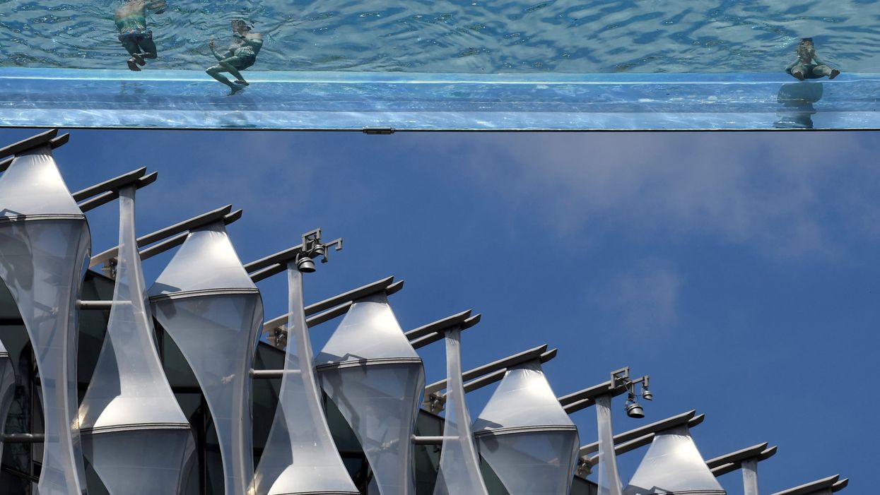 Residents of flats with transparent swimming pool 115ft above the ground are fuming about how expensive it is