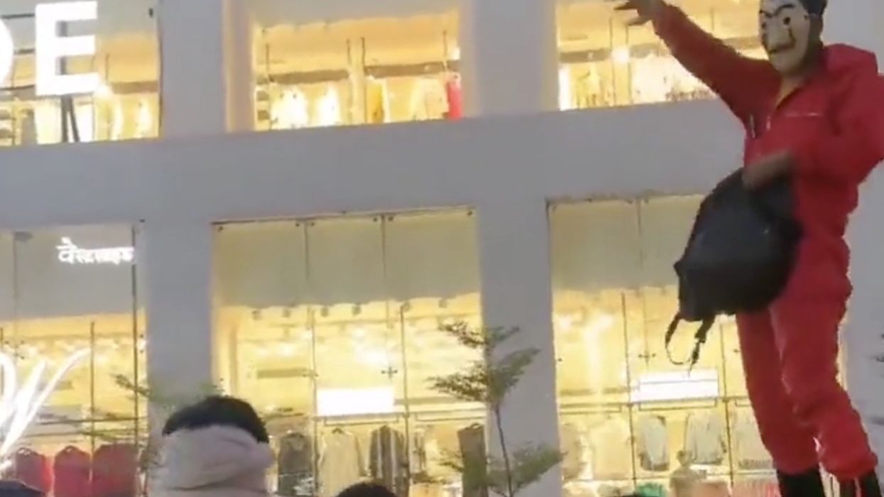 Man arrested for throwing cash at delighted crowd
