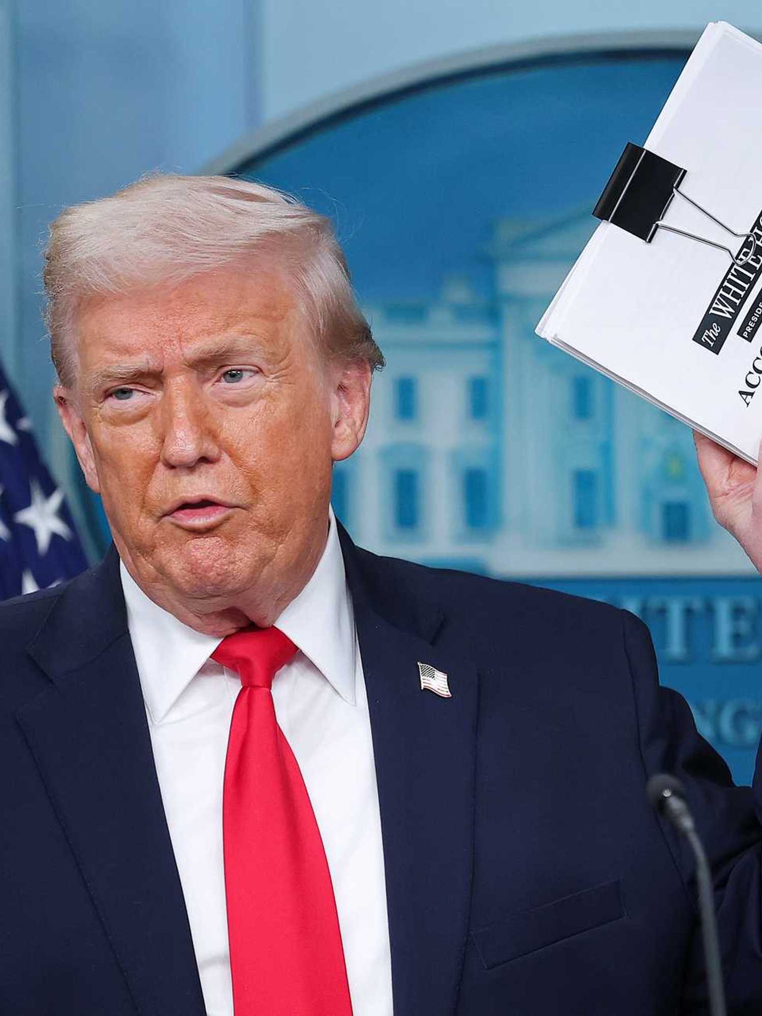Donald Trump shows off 'big book of accomplishments' before throwing it on the floor
