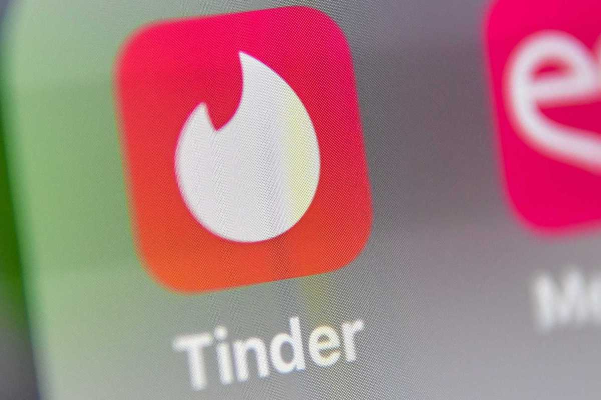 Why has Tinder paused the app's AI Photo Enhance tool?