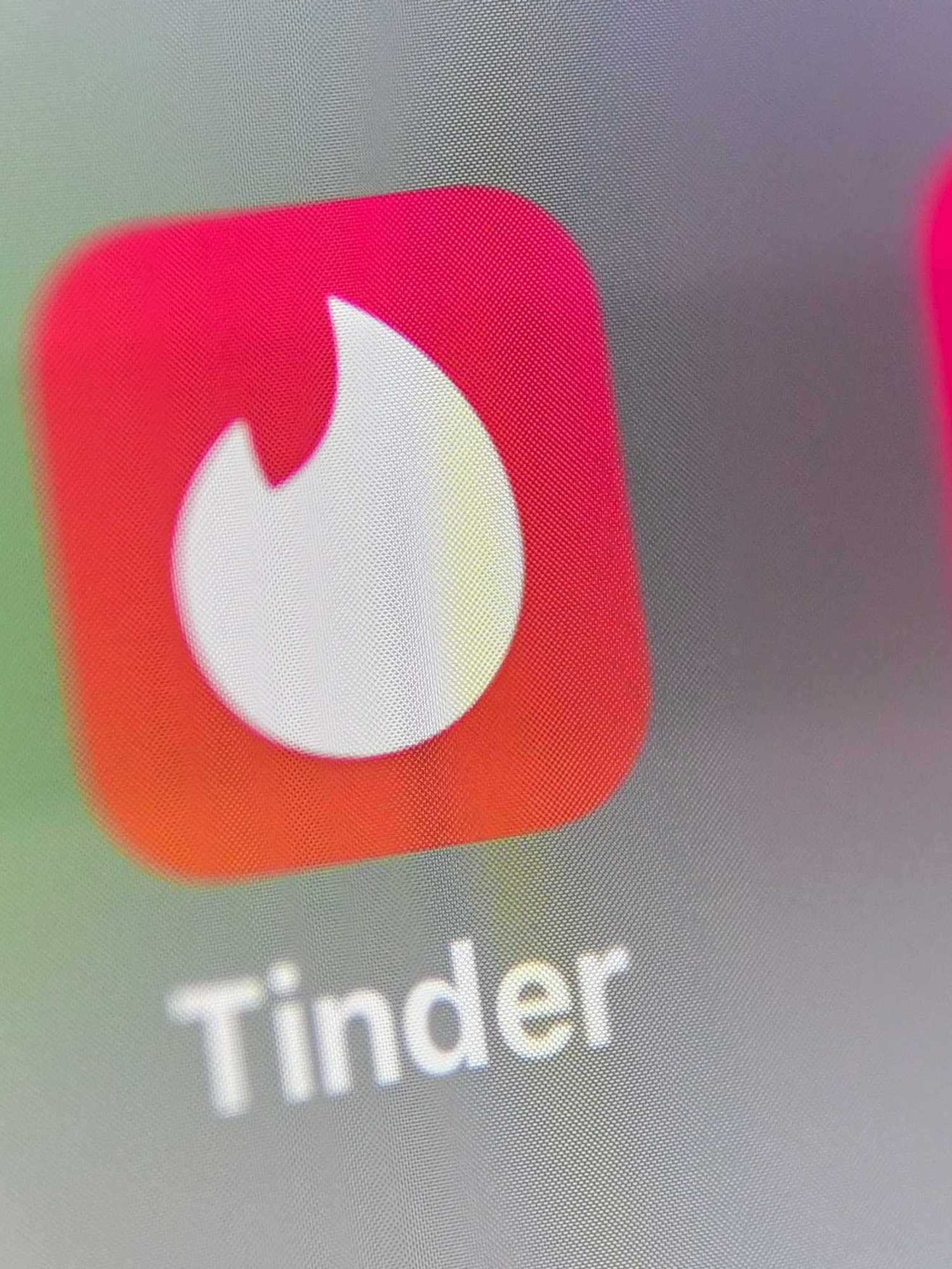 Why has Tinder paused the app's AI Photo Enhance tool?