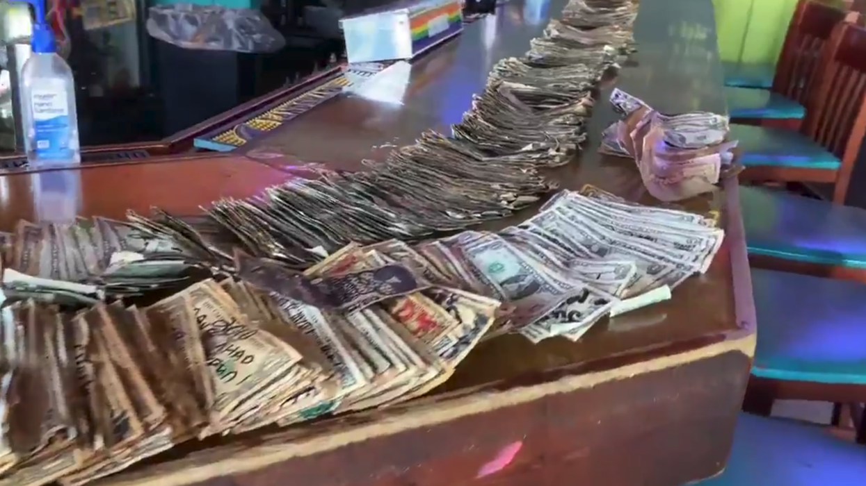 Bar owner peels 15 years worth of notes off the wall to give to unemployed staff