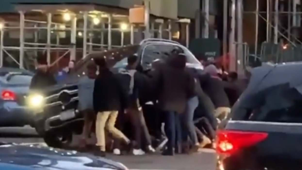 A bunch of strangers lifted up a car to rescue a woman trapped underneath