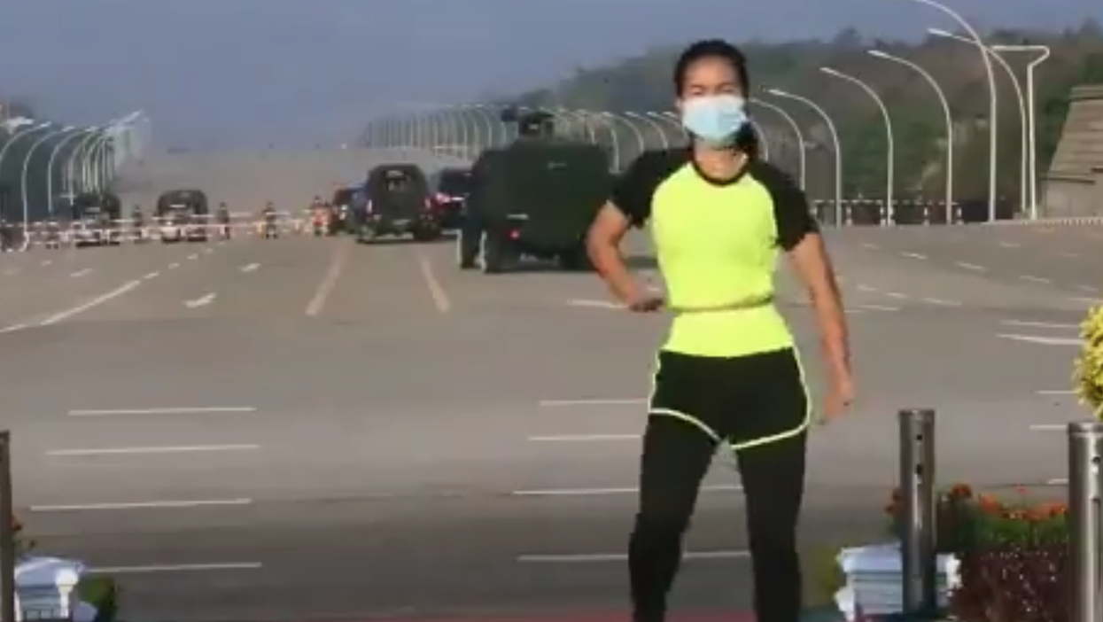 Aerobics instructor in Myanmar continues routine blissfully unaware of military coup happening behind her