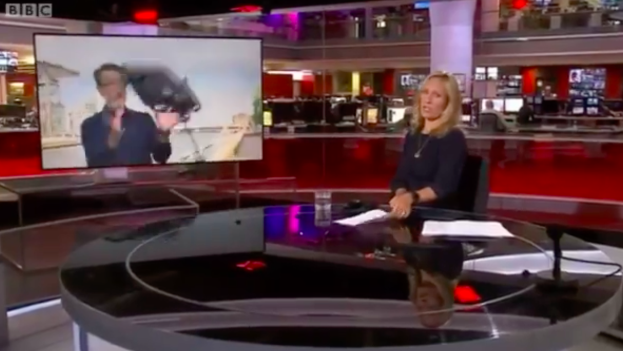 BBC reporter is cool as a cucumber as he narrowly avoids being struck by falling light live on TV