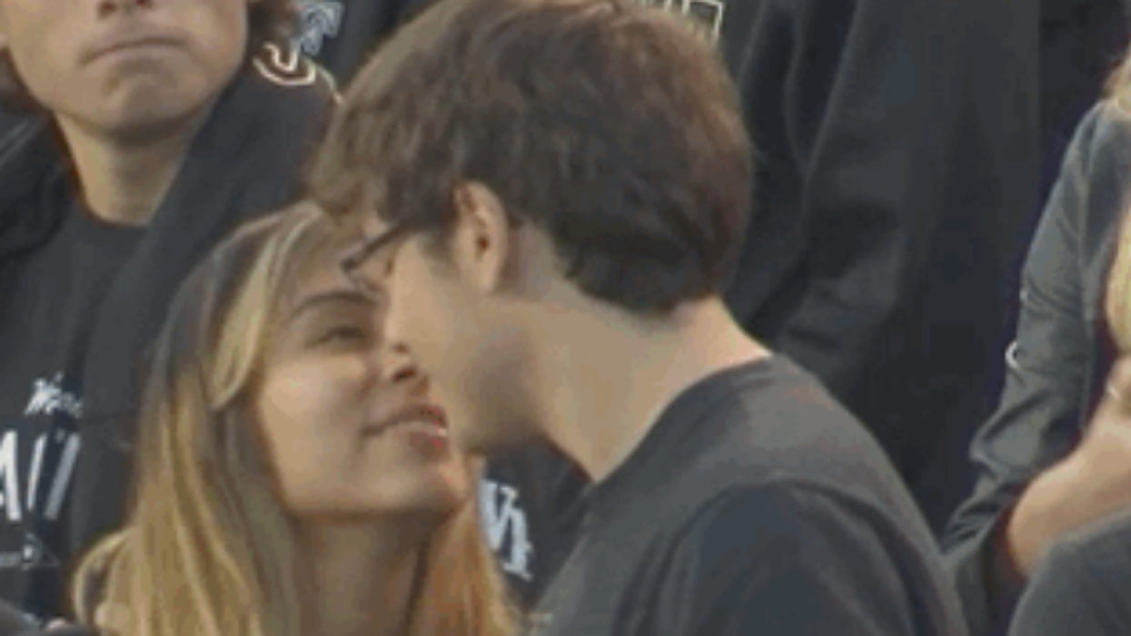Awkward moment man rejects girlfriend's kiss at college football game was apparently 'a joke'