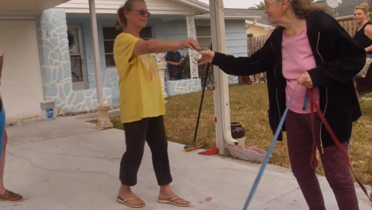 Woman gets evicted from house. Neighbour buys it back and hands her the keys