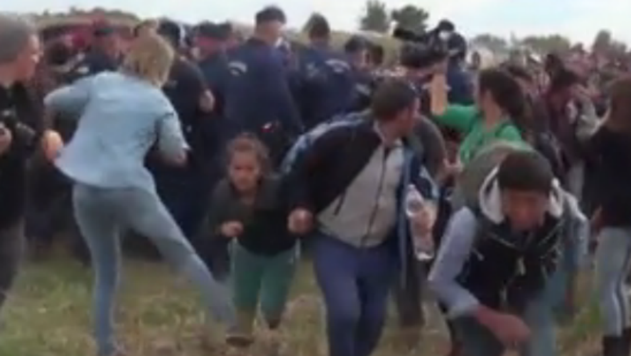Hungarian camerawoman sacked after video shows her kicking and tripping refugees