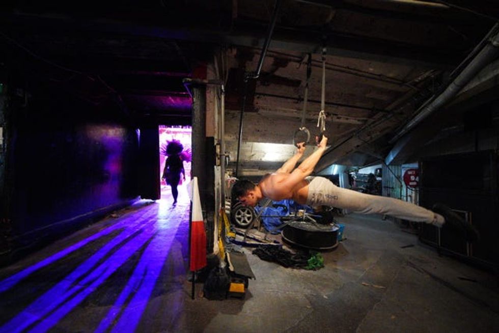 Indira Avila walks past Glenn Folco after going through her routine at Blackpool Tower Circus
