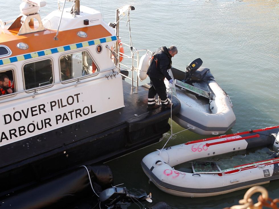Inflatable boats used by migrants who crossed the English Channel from France, are secured by Port of Dover officials in the marina in Dover