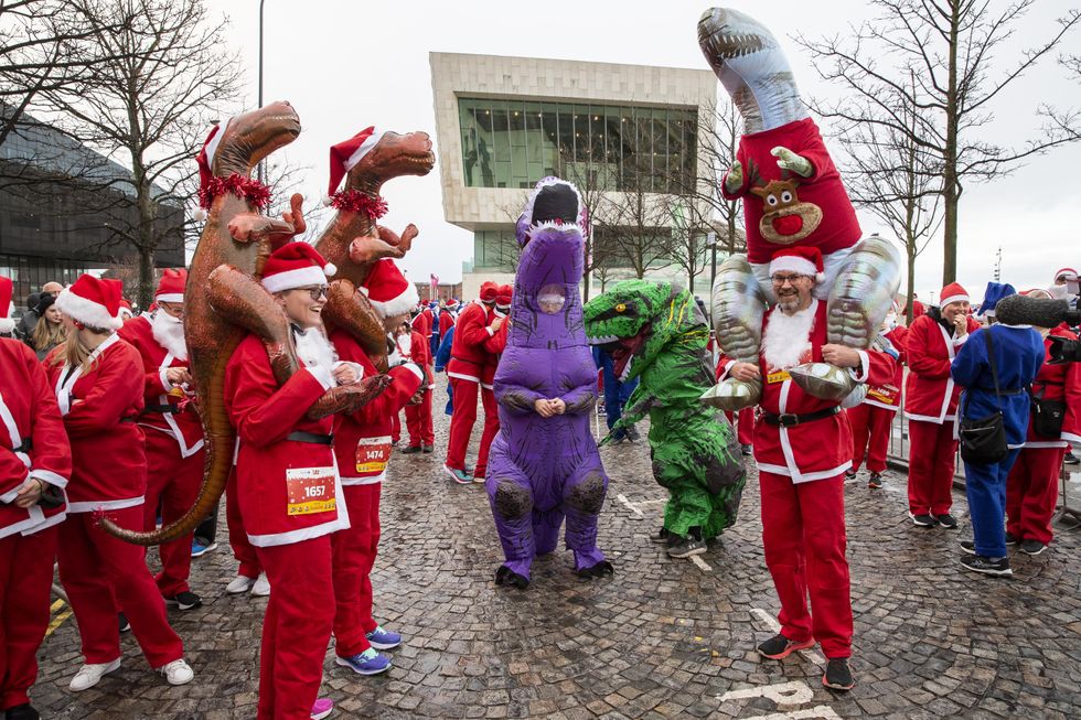 Inflatable dinosaurs wrapped in tinsel at Liverpool\u2019s run (Jason Roberts/PA)