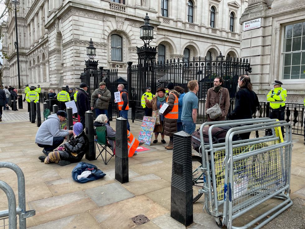 Insulate Britain protesters stage a 24-hour fast outside Downing Street, with more joining remotely from across the UK (Sophie Wingate/PA)
