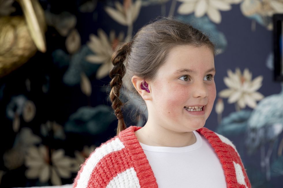 Iona Fagerson, 7, pictured with her new hearing aid