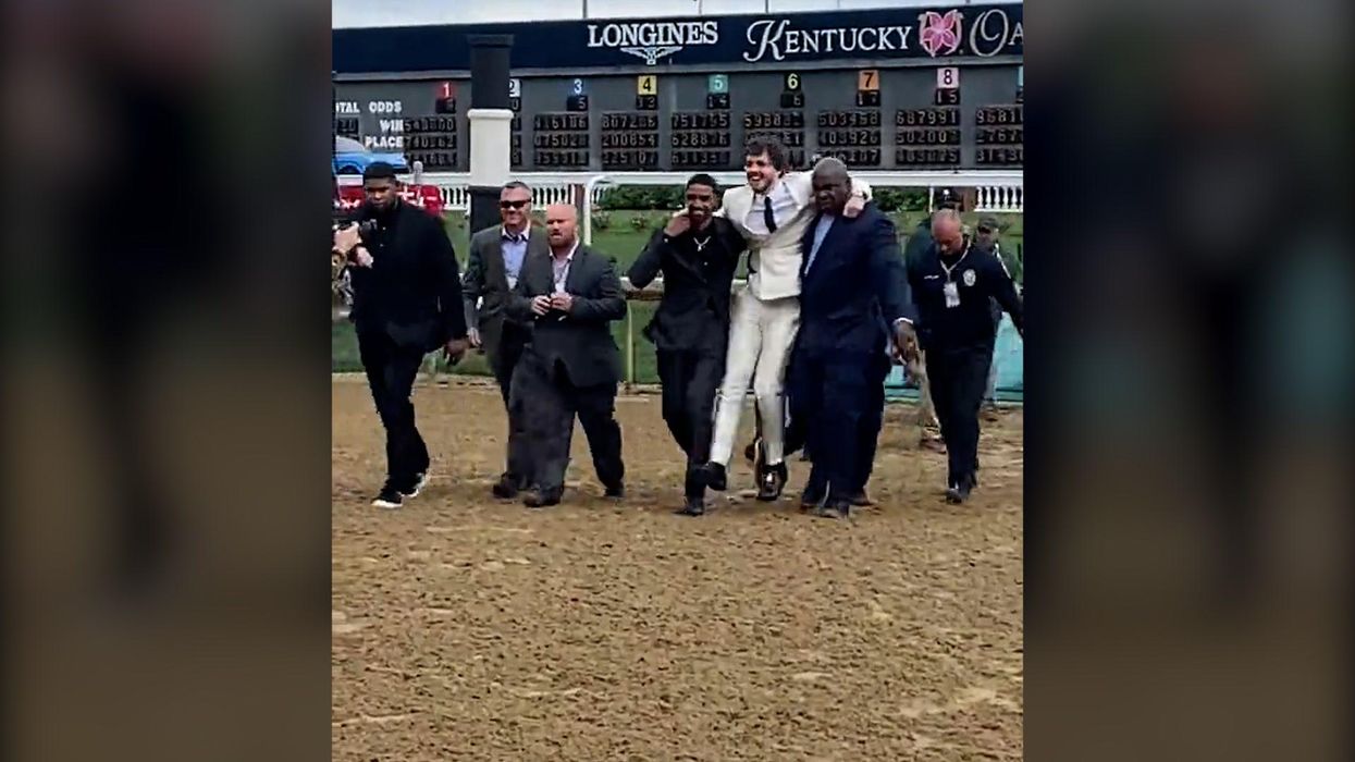 Jack Harlow called out for being carried over field of mud by two black men