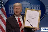 James Austin Johnson as Donald Trump speaking in front of a presidential lectern and holding up a gold-framed copy of an Epstein email.