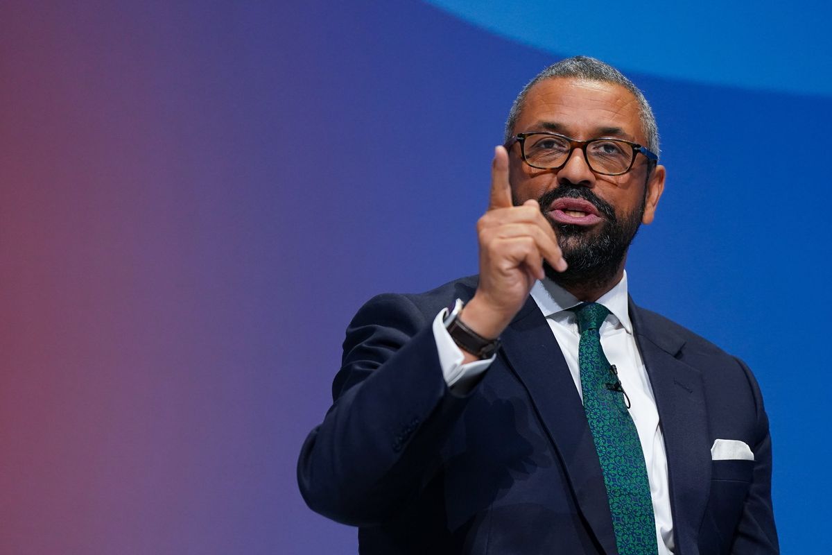James Cleverly, a bearded Black man with glasses and short grey hair, speaks at Conservative Party Conference in Birmingham.