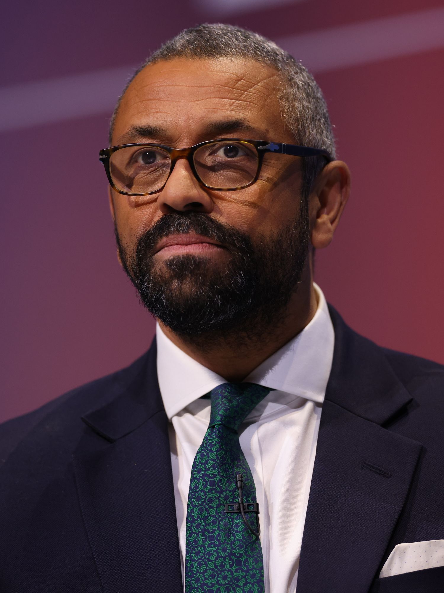 James Cleverly, a Black man with short grey hair and a black beard, on stage at Conservative Party Conference in Birmingham.