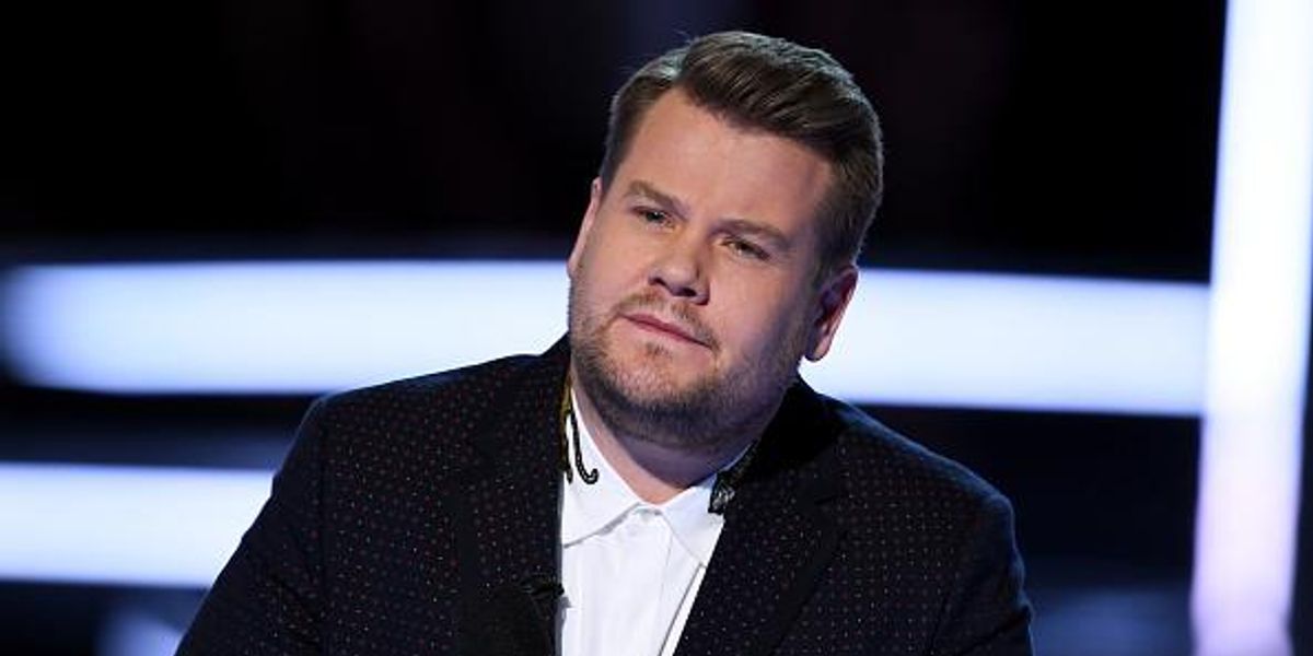 James Corden at a restaurant event, surrounded by fans