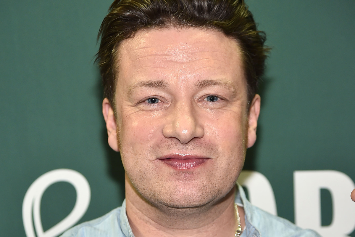 Jamie Oliver, a white man with short brown hair, smiles at the camera.