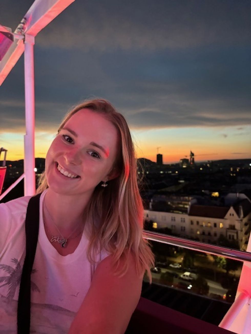Jamilla Blake smiling with a sunset behind her
