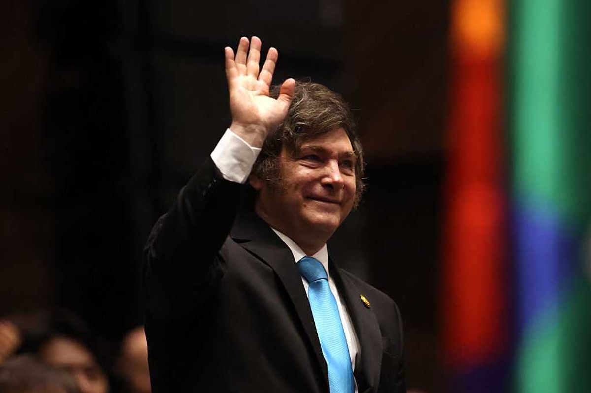 Javier Milei waves during the inauguration ceremony of Bolivia's President-elect Rodrigo Paz.