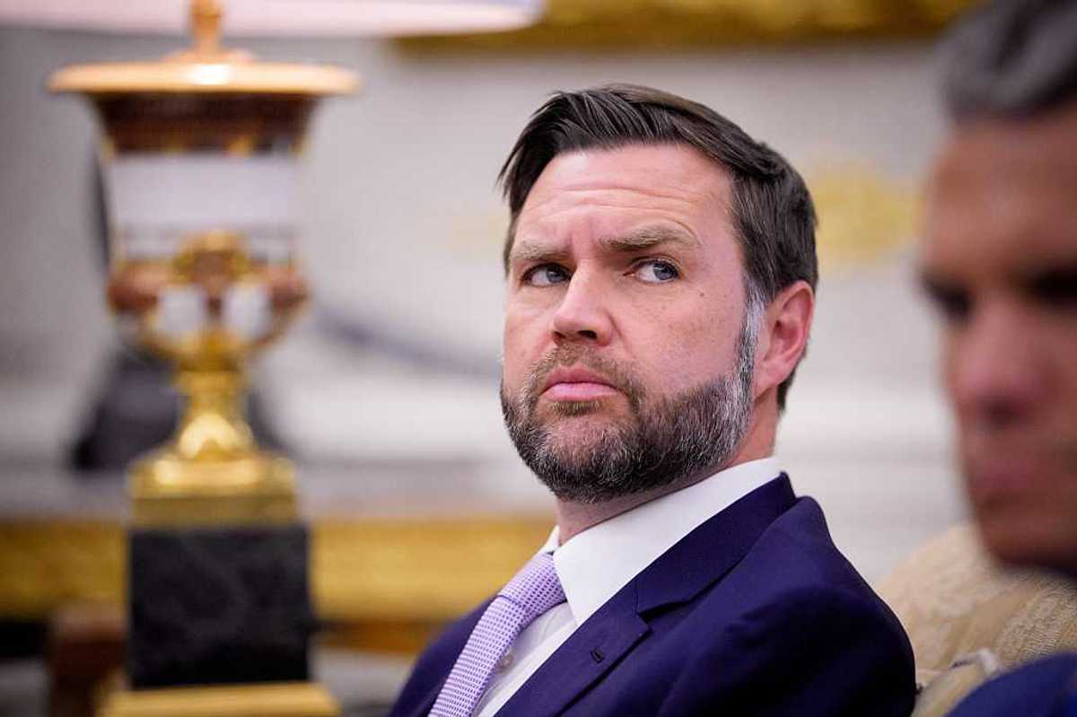 JD Vance looks at something to his left while sitting in the Oval Office.