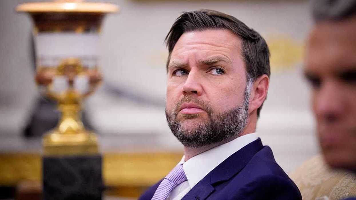 JD Vance looks at something to his left while sitting in the Oval Office.