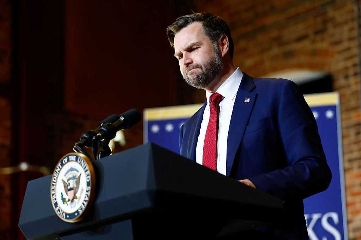 JD Vance pauses as he stands behind the vice presidential lectern during a speech in North Carolina.