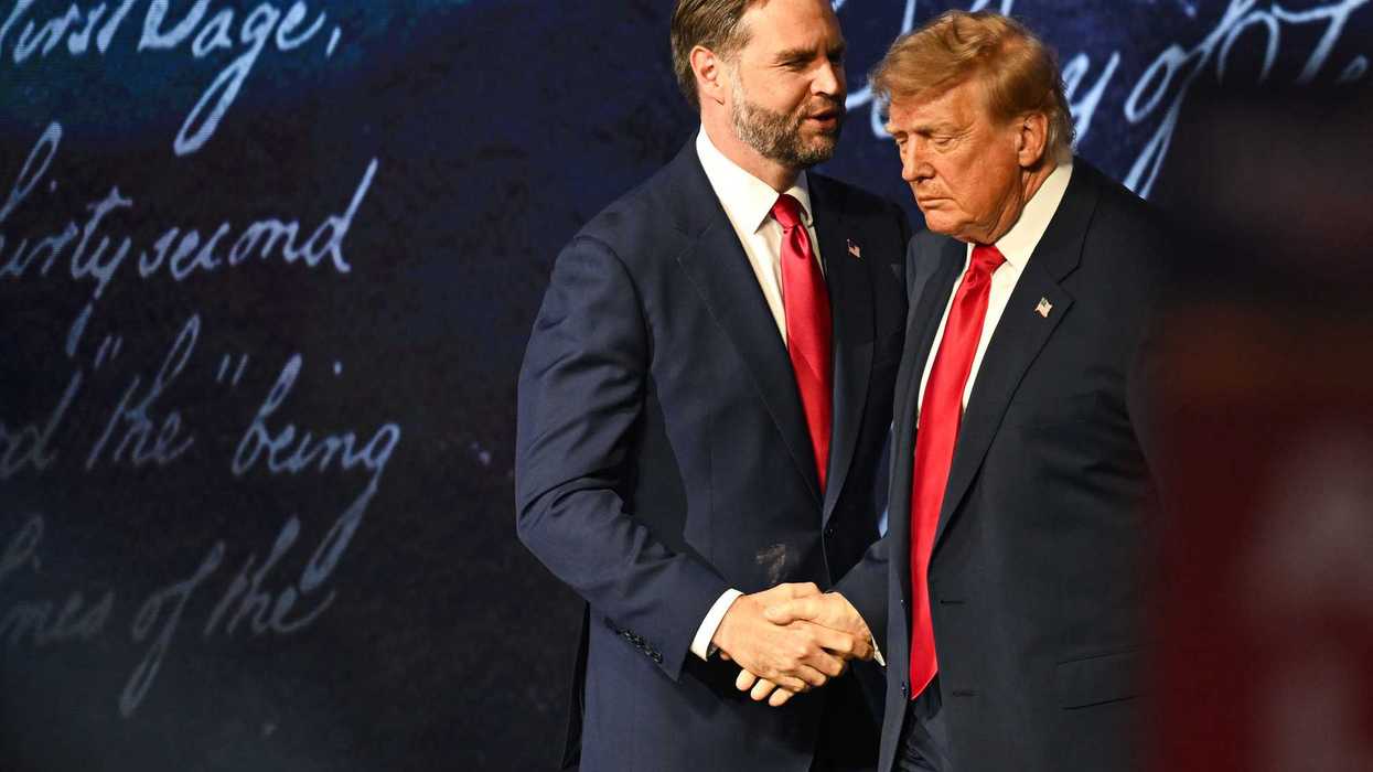 JD Vance shakes Donald Trump's hand on stage at the midterm convention.